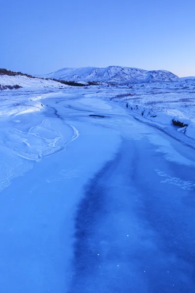 Frozen river in Thingvellir, Iceland in winter at dawn — Stock Photo, Image
