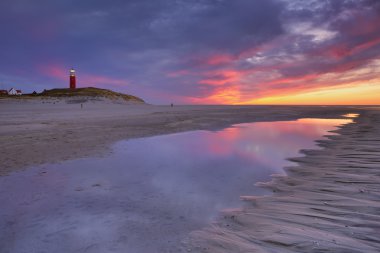 Lighthouse on Texel island in The Netherlands at sunset clipart