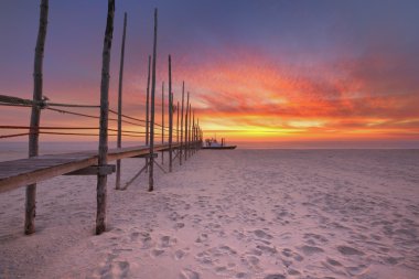 Seaside jetty at sunrise on Texel island, The Netherlands clipart