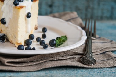 Süzme peynir pişmiş puding, ekşi krema ve yaban mersini 
