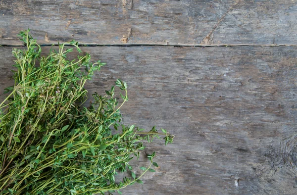 Bunch of fresh estragon on a wooden table background — Stock Photo, Image