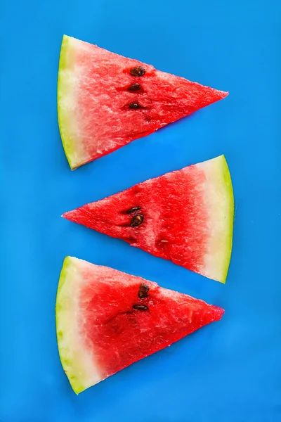 Tower of slices of watermelon on a blue background — Stock Photo, Image