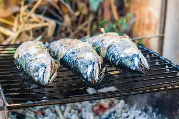 Mackerel fish prepared on the grill in smoke
