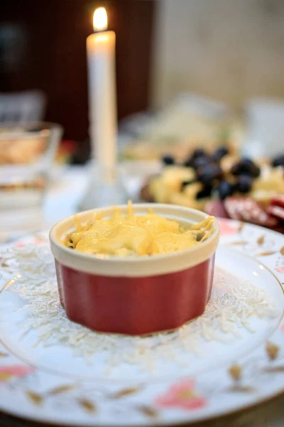 Chicken and cheese julienne in a cocotte-ramequin on the festive table — Stock Photo, Image