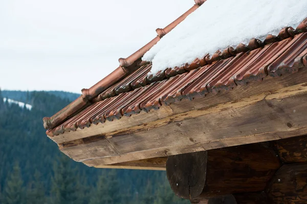 snow on the roof at winter mountains.