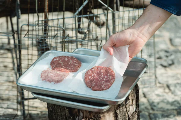 Beef and Pork Patty for Burger. Cooking Cutlets on Mangal. Grill Minced Meat. Chef Cooks burger in street outdoors. Summer Picnic in Nature. Tasty Meat Dish. Closeup