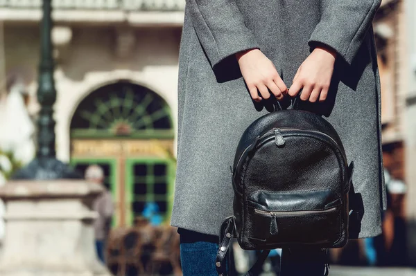 Young stylish woman walking in autumn city, cold season, wearing leather backpack, fashion trend — Stock Photo, Image