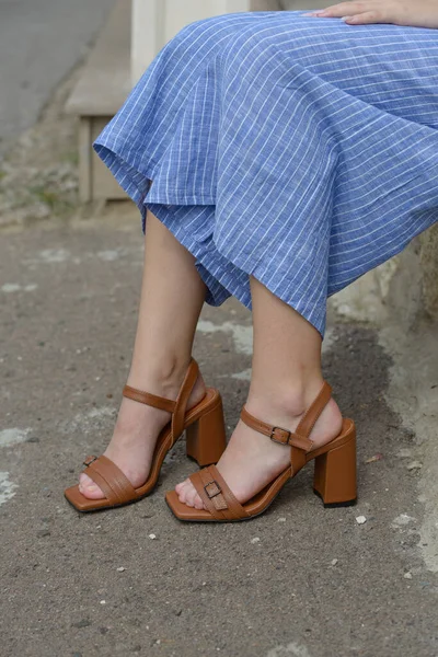 Vista de cerca de las piernas de una mujer con sandalias de tacón alto marrón al aire libre en la ciudad — Foto de Stock