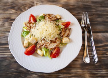 Parmesan peyniri ve tavuk ile beyaz kase taze Sezar salataya