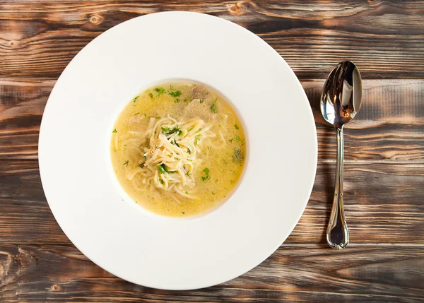 Chicken soup with noodles and vegetables in white bowl — Stock Photo, Image