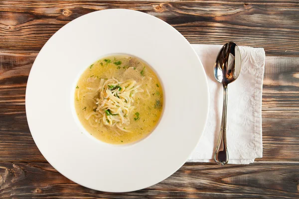 Chicken soup with noodles and vegetables in white bowl — Stock Photo, Image