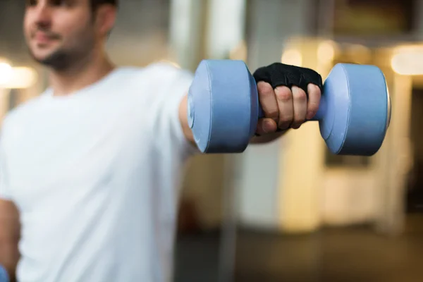 sporty men hands with light blue dumbbells