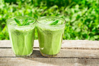 Spinach smoothie on a wooden background