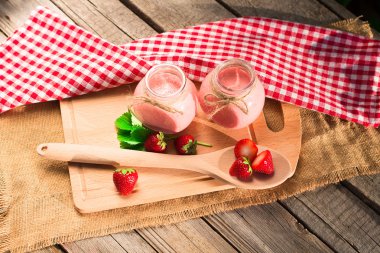 Drink smoothies summer strawberry on wooden table.