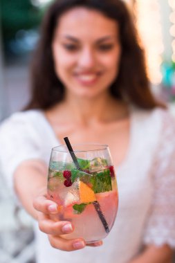 beautiful smiling woman drinking cold lemonade berry, outdoor
