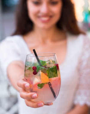 beautiful smiling woman drinking cold lemonade berry, outdoor