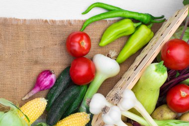 Harvest time. A basket of vegetables on a wooden table