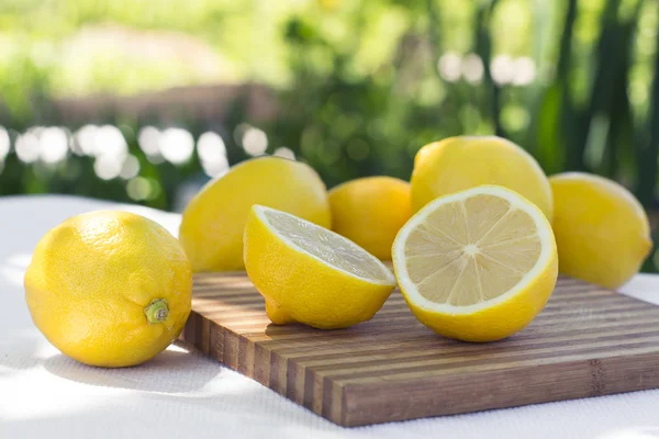 Fresh lemons on the table on natural background — Stockfoto