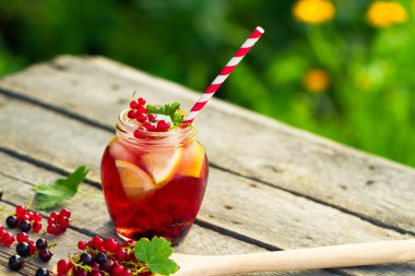 Red currant drink on wooden table