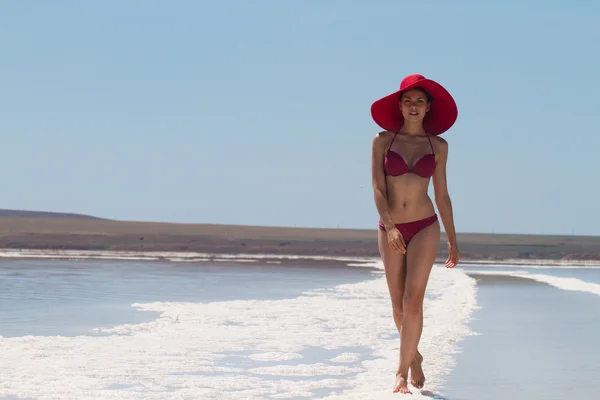 The lake with salt water. Baskunchak . Beautiful woman sunbathin
