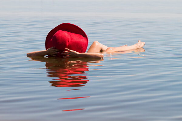 The lake with salt water. Baskunchak . Beautiful woman sunbathin