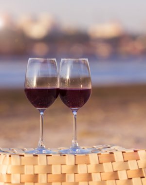 two glasses of red wine at sunset
