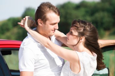 young smile couple romantic kissing sitting in car , summer time