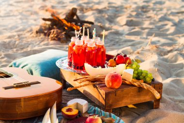 Picnic on the beach at sunset clipart