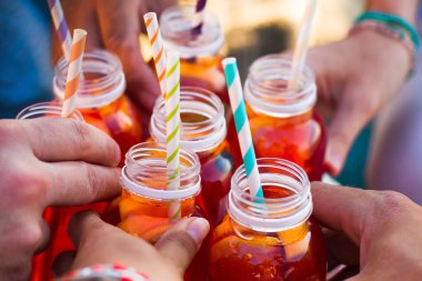 group of friends holding drinks, toast , close-up