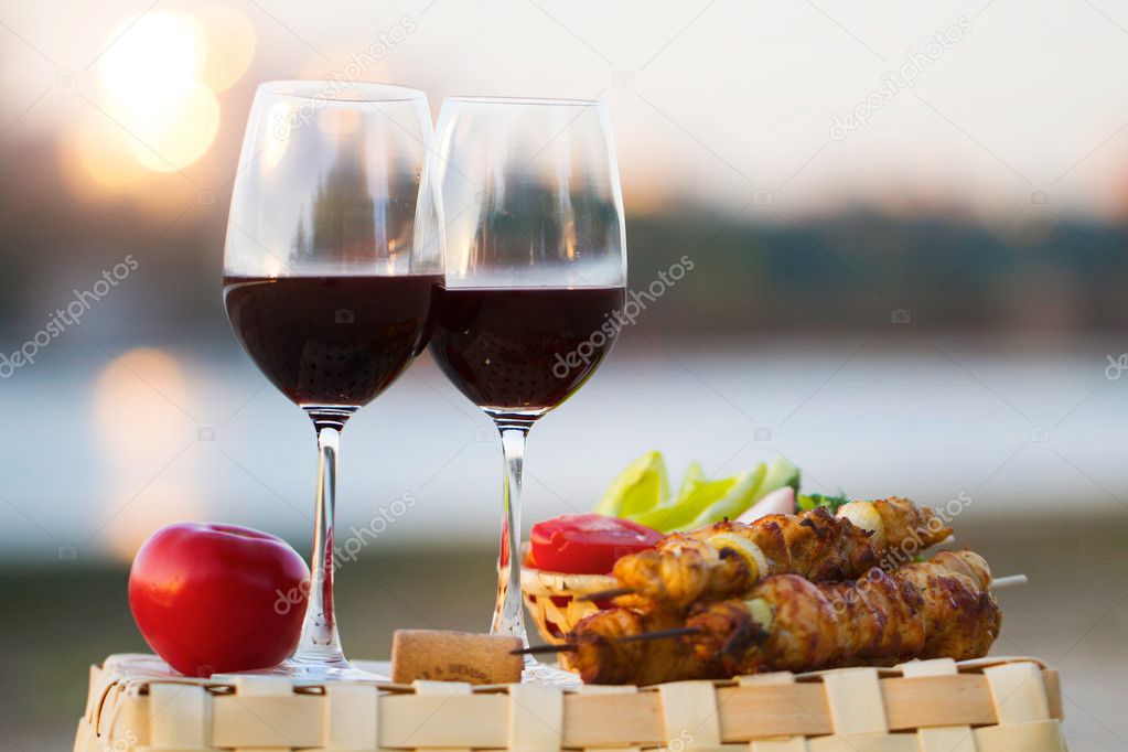 two glasses of red wine at sunset