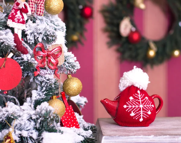 Red kettle with tea at Christmas tree — Stock Photo, Image