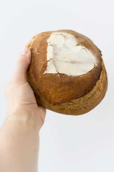 Artisan bread in hand on white background — Stock Photo, Image