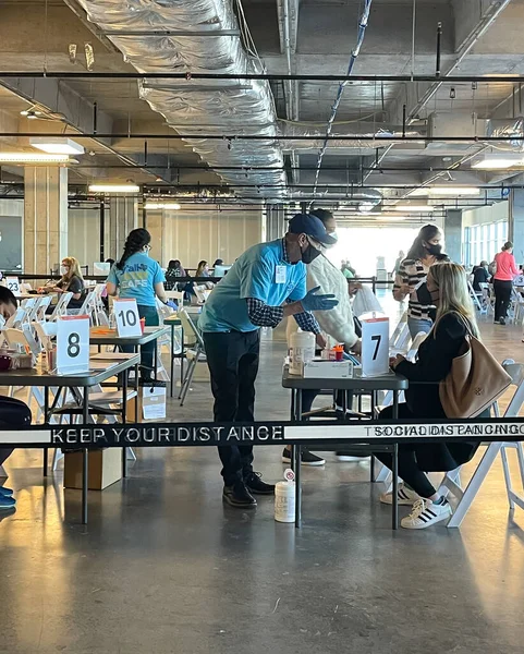 Frisco TX, USA - March 26, 2021: Indoor view of hospital assistants helping people registering the covid-19 vaccine