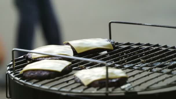 Kuchař odebrat patty karbanátky se sýrem z mřížky — Stock video