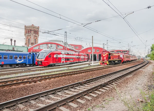 Depot of a name of Ilyich. Train ES2-002 Stadler KISS RUS (AERO) "Eurasia", wagons of express train "Rex"and shunting diesel locomotive with attached to a train — Stock Photo, Image