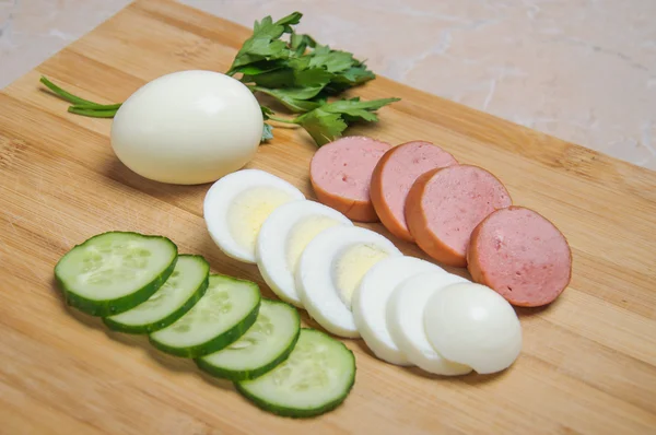 Sliced egg, sausage and cucumber — Stock Photo, Image