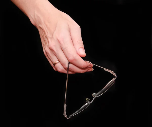 Eyeglasses in a woman's hand — Φωτογραφία Αρχείου