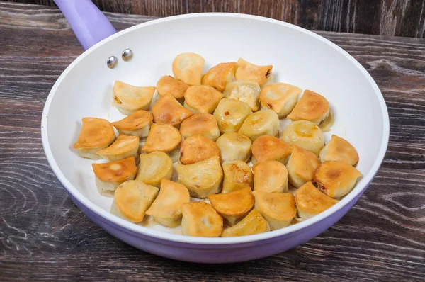 Fried dumplings in the pan — Stock Photo, Image