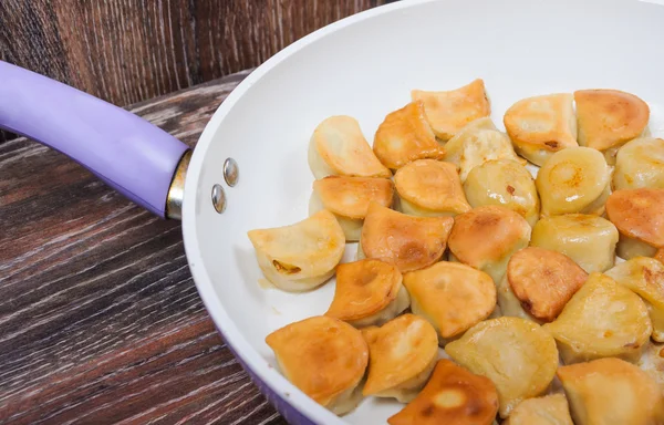 Fried dumplings in the pan — Stock Photo, Image