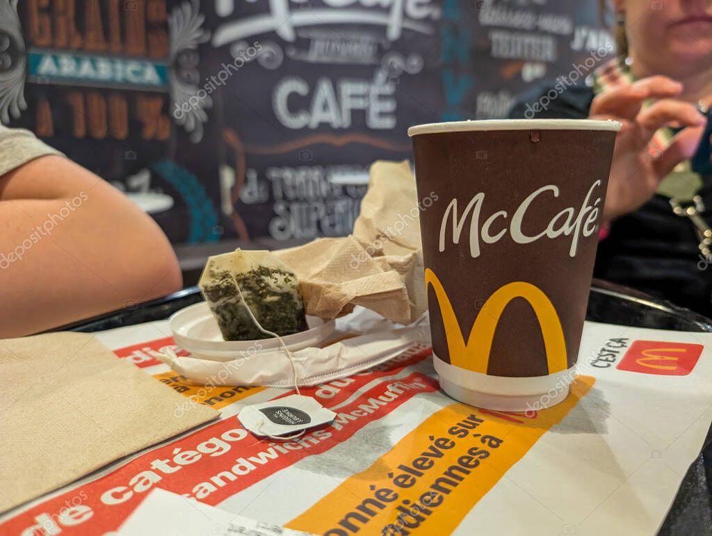 Canada, 07 July 2025 : Tea bag, McCafe cup, napkins, tray, people, advertising, French, branding.