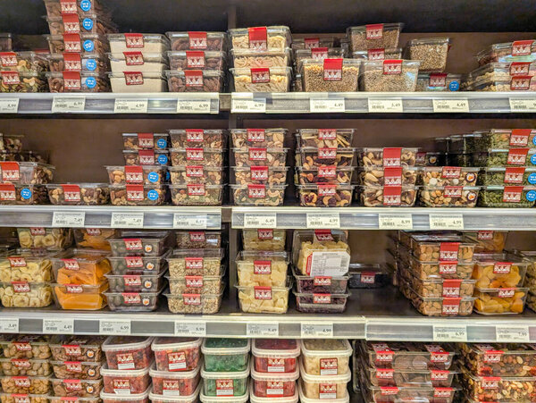 Canada, 09 August 2025 : Supermarket shelf filled with various containers of mixed dried nuts