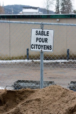 Kanada, Quebec, 27 Kasım 2025: Halka açık kum yığını kışın vatandaşlar için metal çitlerin arkasında