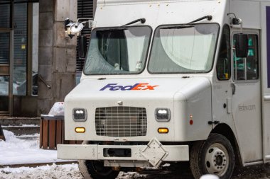 Kanada, Montreal, 24 Aralık 2025: Karlı şehir caddesinde kış mevsiminde seyir eden teslimat kamyonu