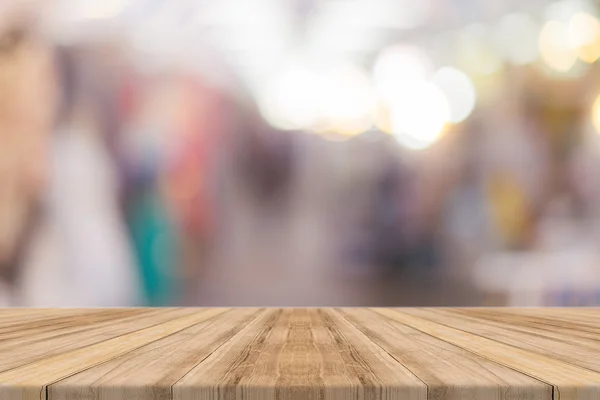 Träskiva tomma bord framför människor shopping på marknaden rättvis bakgrund. Perspektiv trä och oskärpa på marknaden - kan användas för visning eller montage dina produkter - vintage effekt stil bilder. — Stockfoto