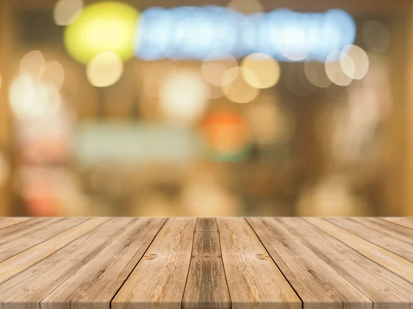 Wooden board empty table in front of blurred background. Perspective brown wood over blur in coffee shop - can be used for display or montage your products.Mock up for display of product. — Stock Photo, Image