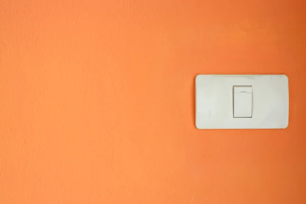 White light switch, turn on or turn off the lights on orange wal — Stock Photo, Image