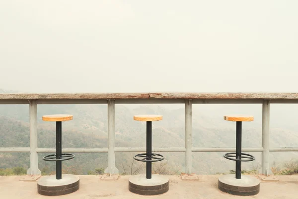 Magnificent outdoor terrace with chairs on sunny terrace with bay view and decoration in contemporary home, Vintage filtered image.