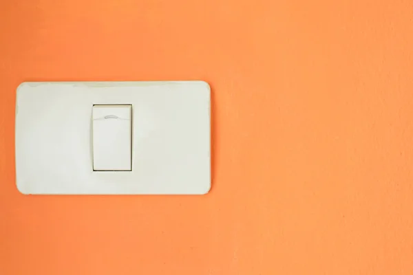 White light switch, turn on or turn off the lights on orange wal — Stock Photo, Image