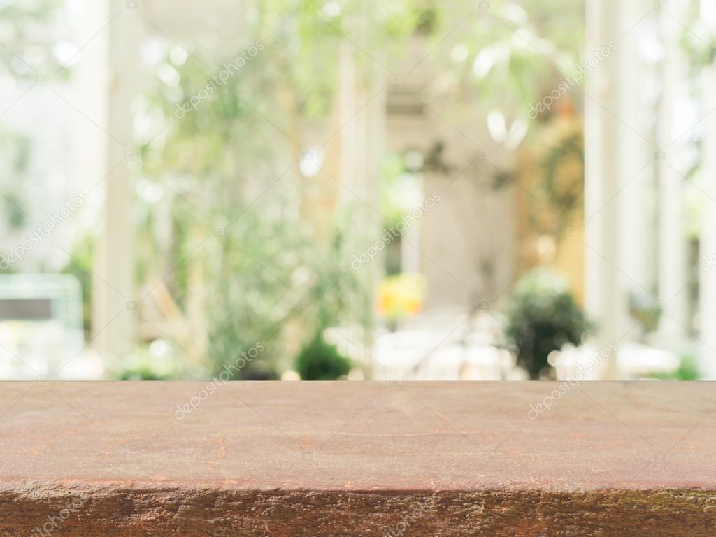 Stone board empty table in front of blurred background. Perspective brown stone over blur in coffee shop - can be used for display or montage mock up your products. vintage filtered image.