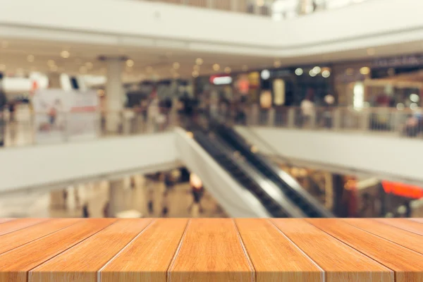 Wooden board empty table blurred background. Perspective brown wood over blur in department store - can be used for display or montage your products.Mock up for display of product. — Stock Photo, Image